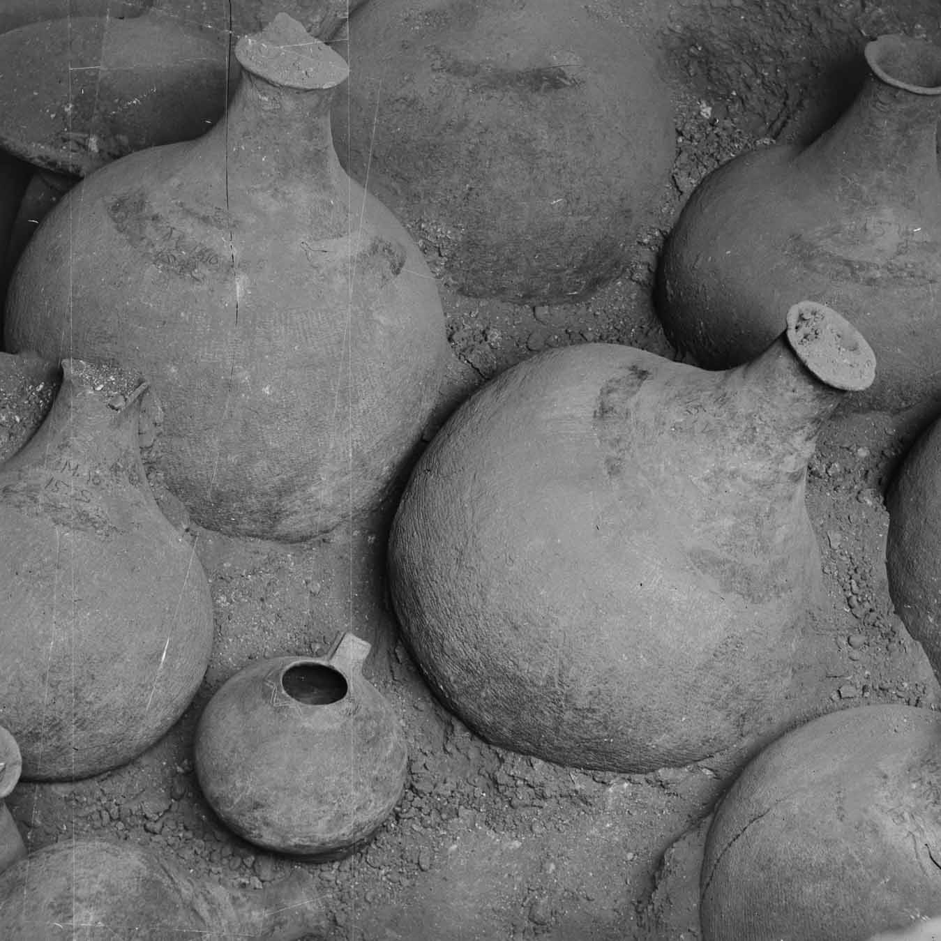 Black and white photo of very large ceramic bottles