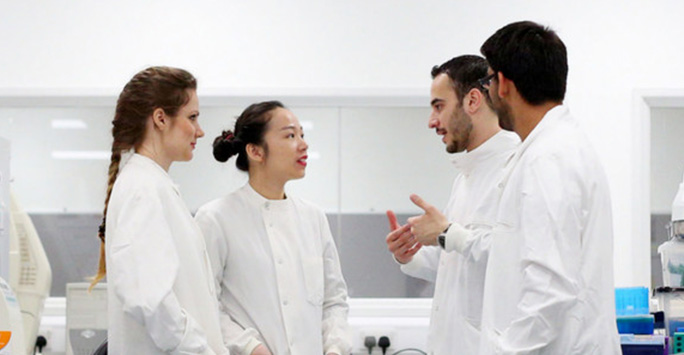 Postgraduate students in lab coats