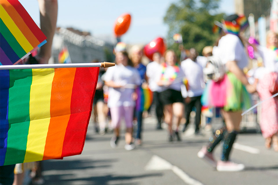 Pride flag with blurred background of a pride parade