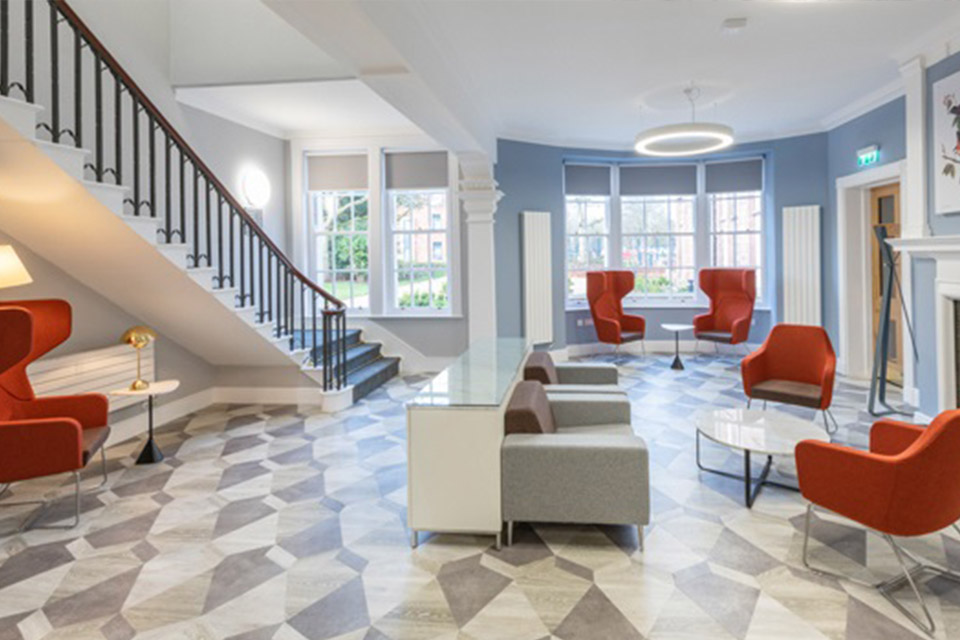 Conference Centre entrance hall with large armchairs and low tables and a staircase