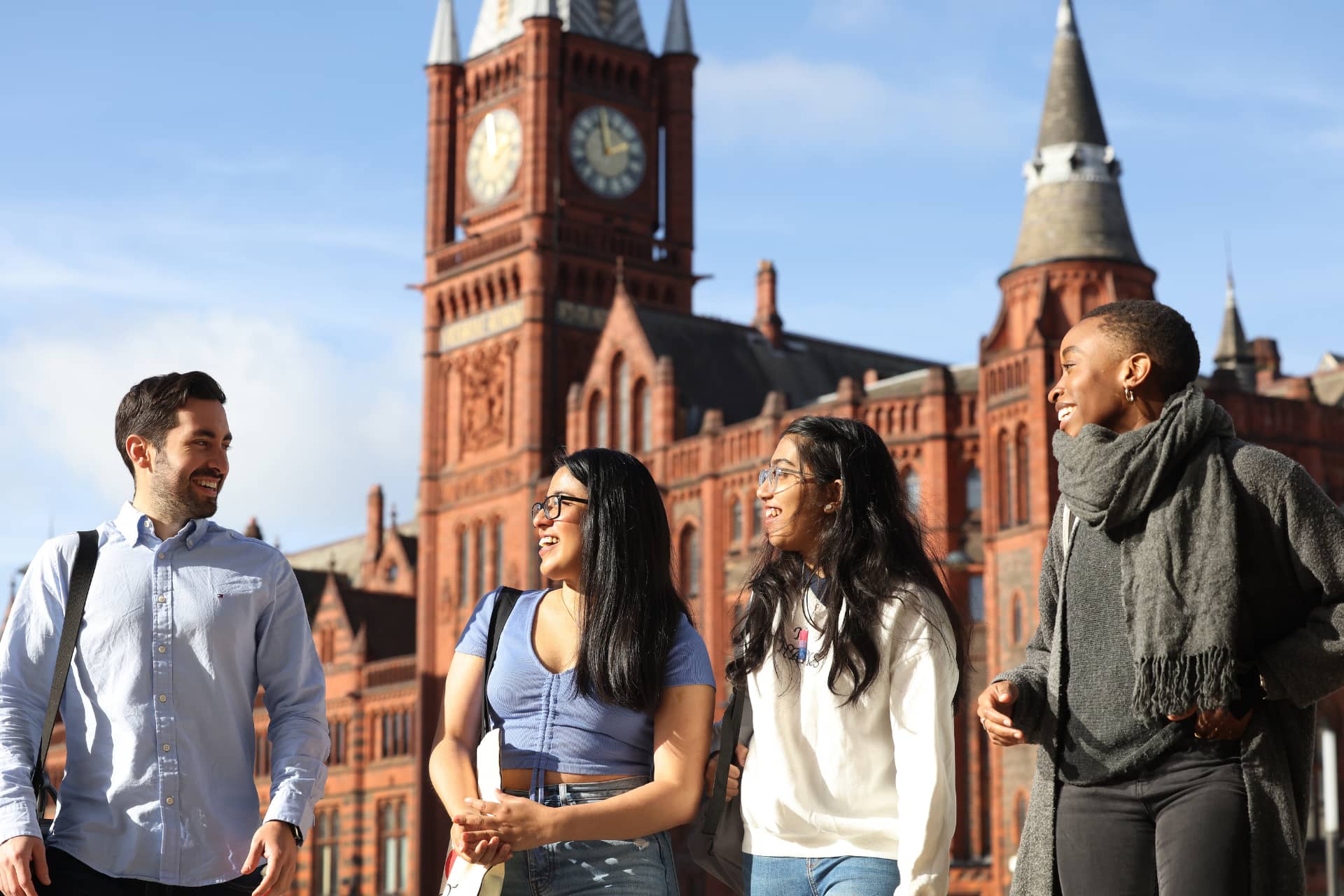 Students chatting and walking in front of the Victoria Building