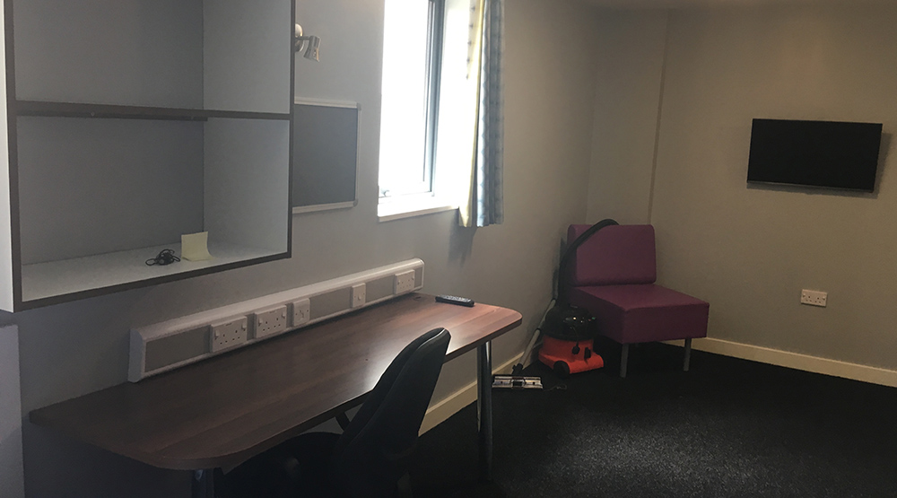 Study area and television in a Deluxe Studio at Crown Place