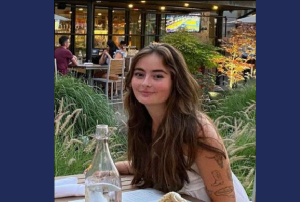 Medicine and Surgery student Rachel smiling sitting at a table