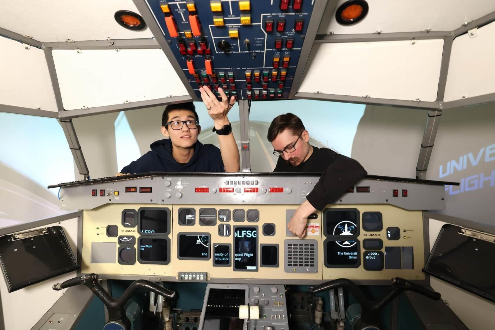 two aerospace engineering students in a flight simulator