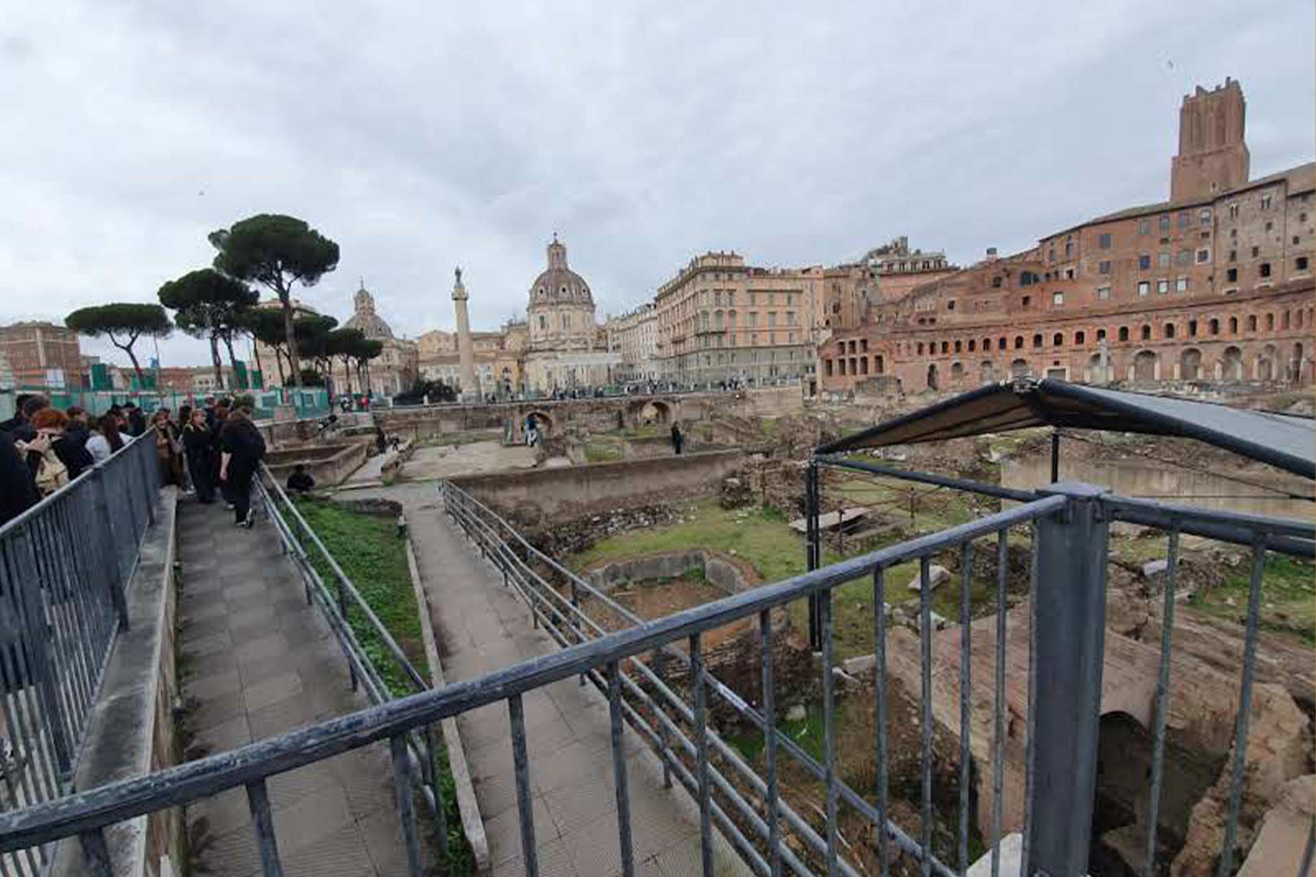Old Roman ruins and a large old grand stone building to the right hand side