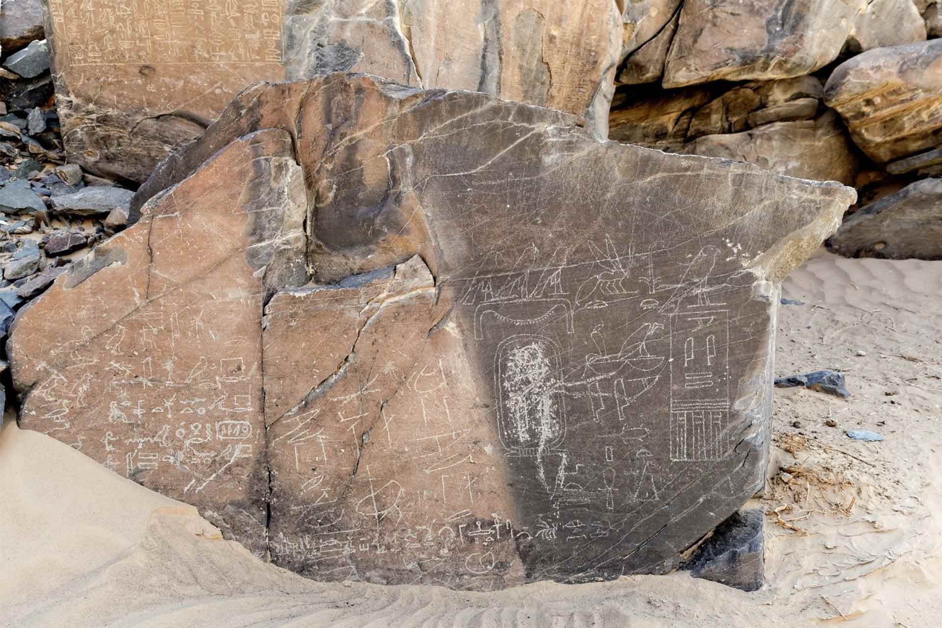 A large flat rock with inscriptions carved into it.