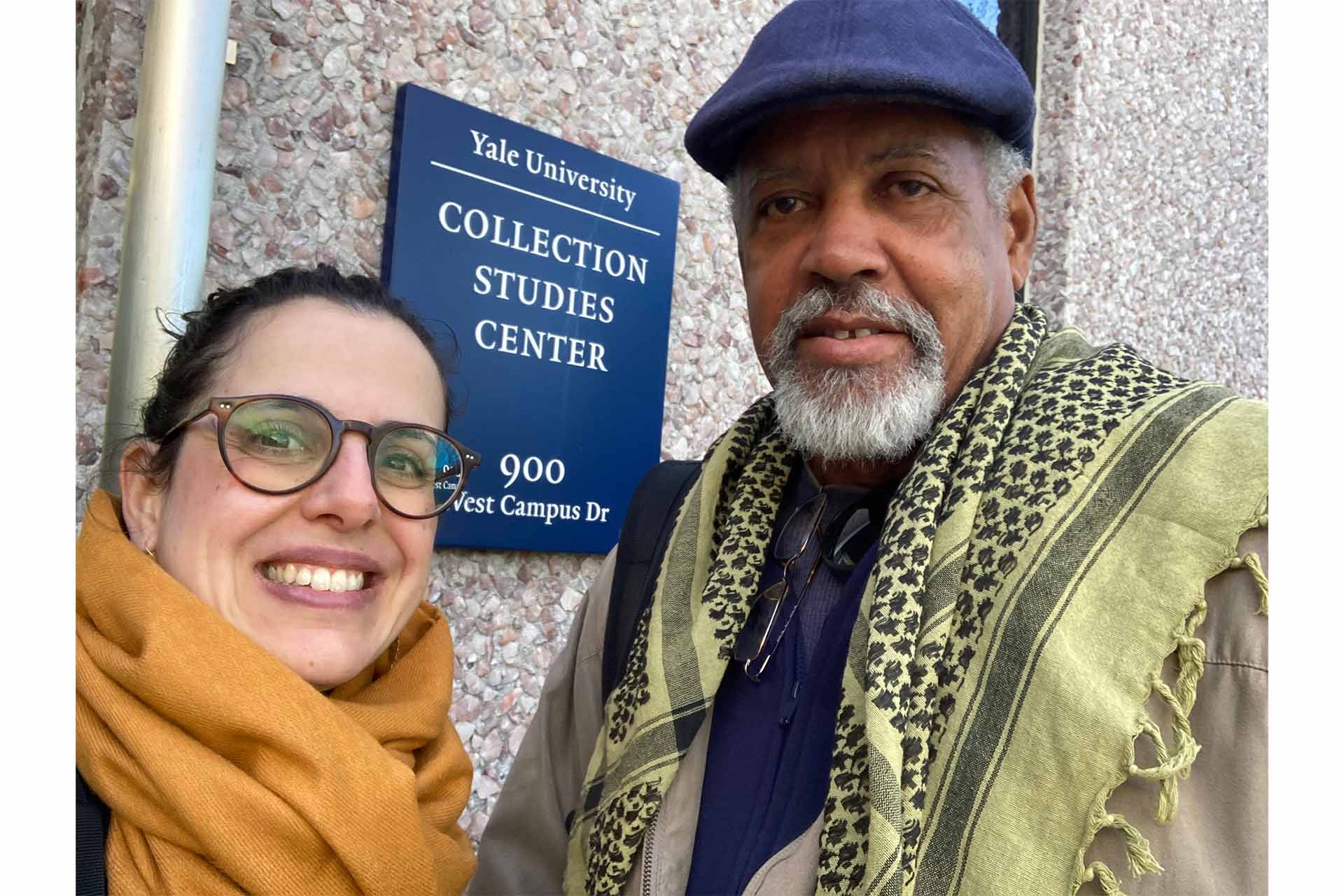 Dr Reg Murphy and Dr Marín-Aguilera standing outside a building with a Yale plaque on the wall behind them.