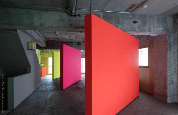 Large angles rectangular panels in primary colours inside a warehouse space.