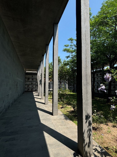 Square concrete columns on the edge of a garden space.