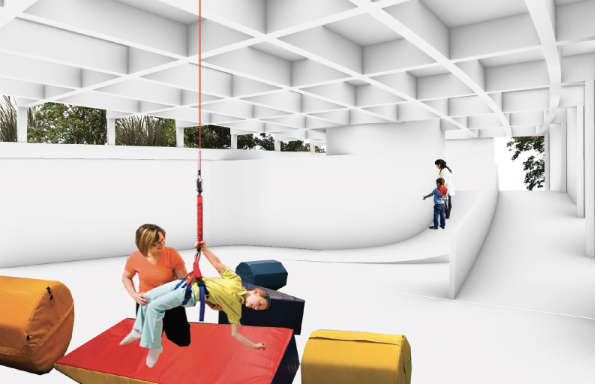 A child hangs from harness exploring the tactile environment of a building designed for special sensory needs. They are guided by a smiling woman kneeling next to them.