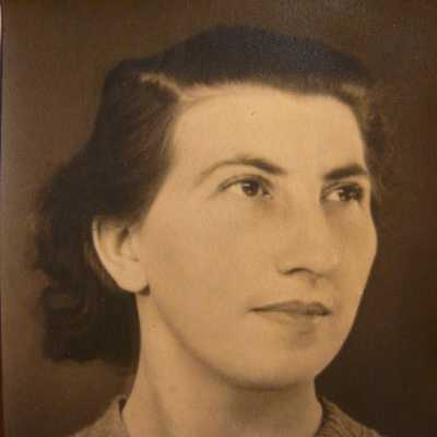 Sepia toned photograph of a woman with short combed hair and wearing a jumper.