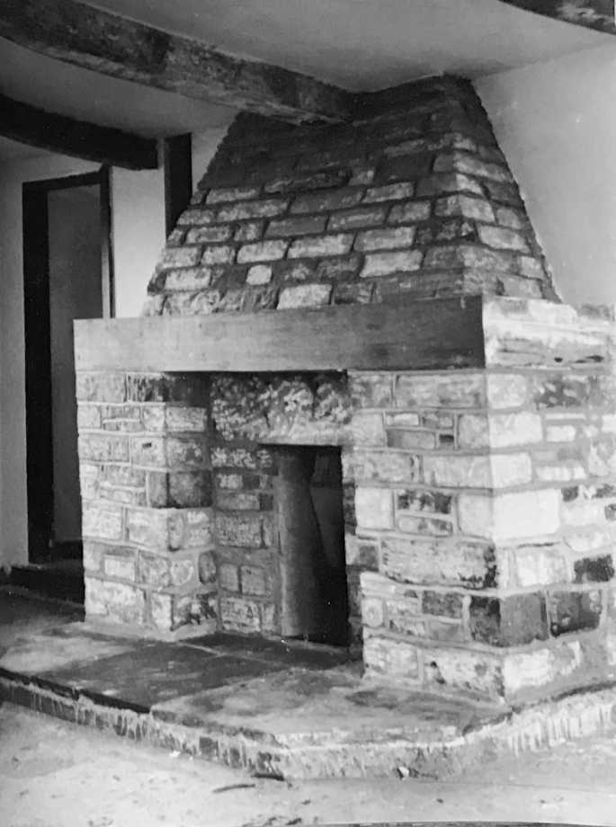 Stone and brick fireplace in a rebuilt barn and cottage conversion.