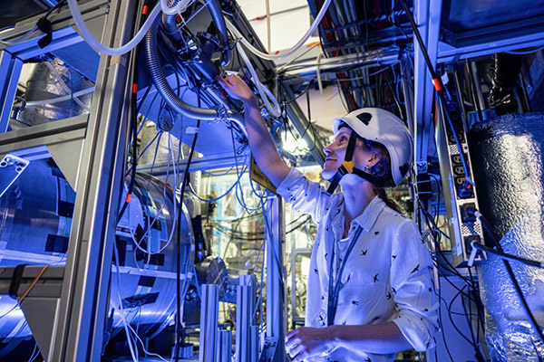 BASE physicist Barbara Latacz in front of the experiment’s cryostat