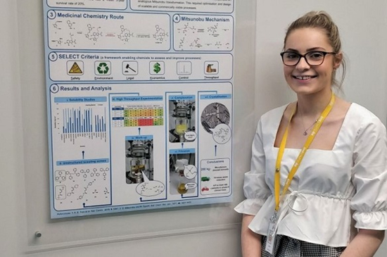 Harriet McNicholl next to chemistry poster