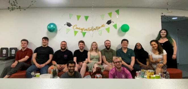 A diverse group of people relaxing on a couch in an office
