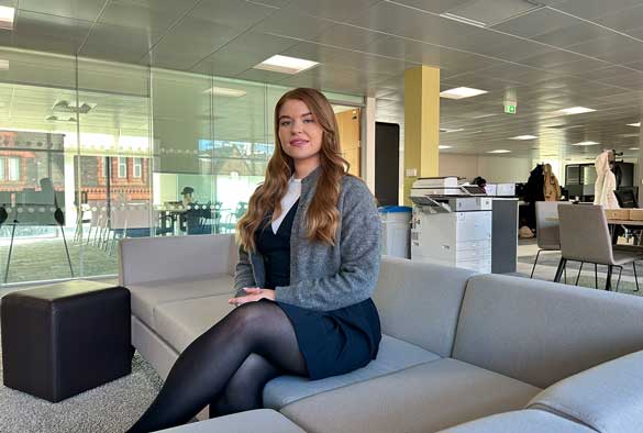 Bronagh O'Loan sitting on a sofa in an office on campus