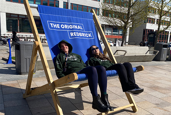 IT Services staff taking a break on a giant deck chair during their event
