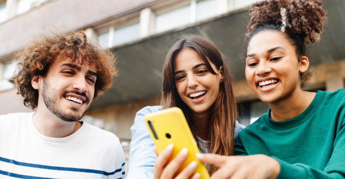 Group of people looking at a phone