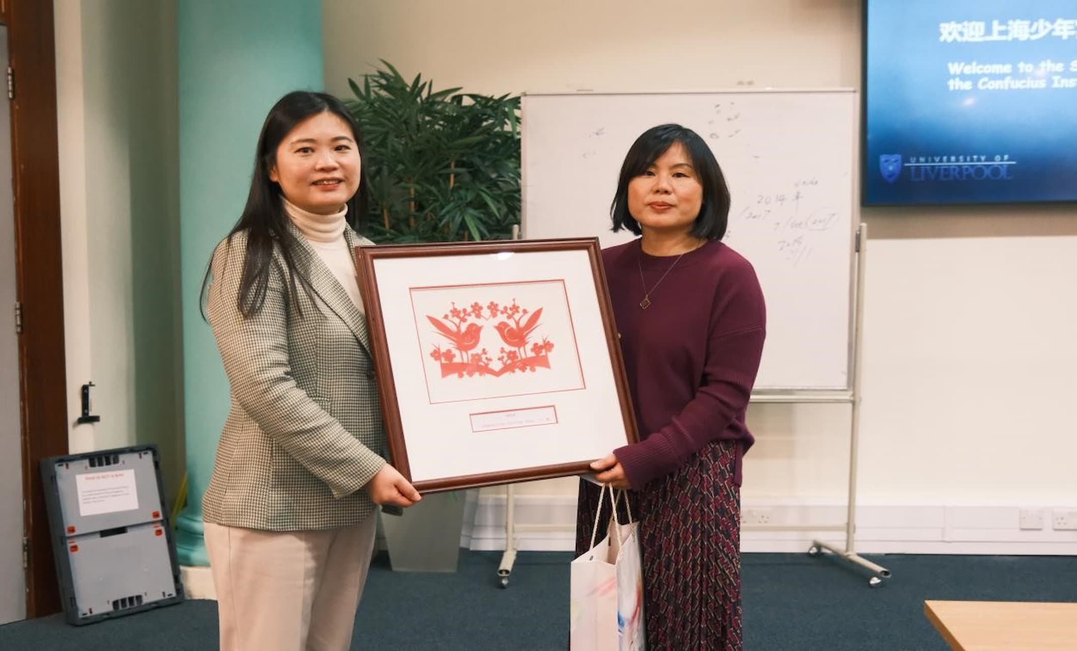 Dr Penny Ding being presented with Chinese paper cuttings