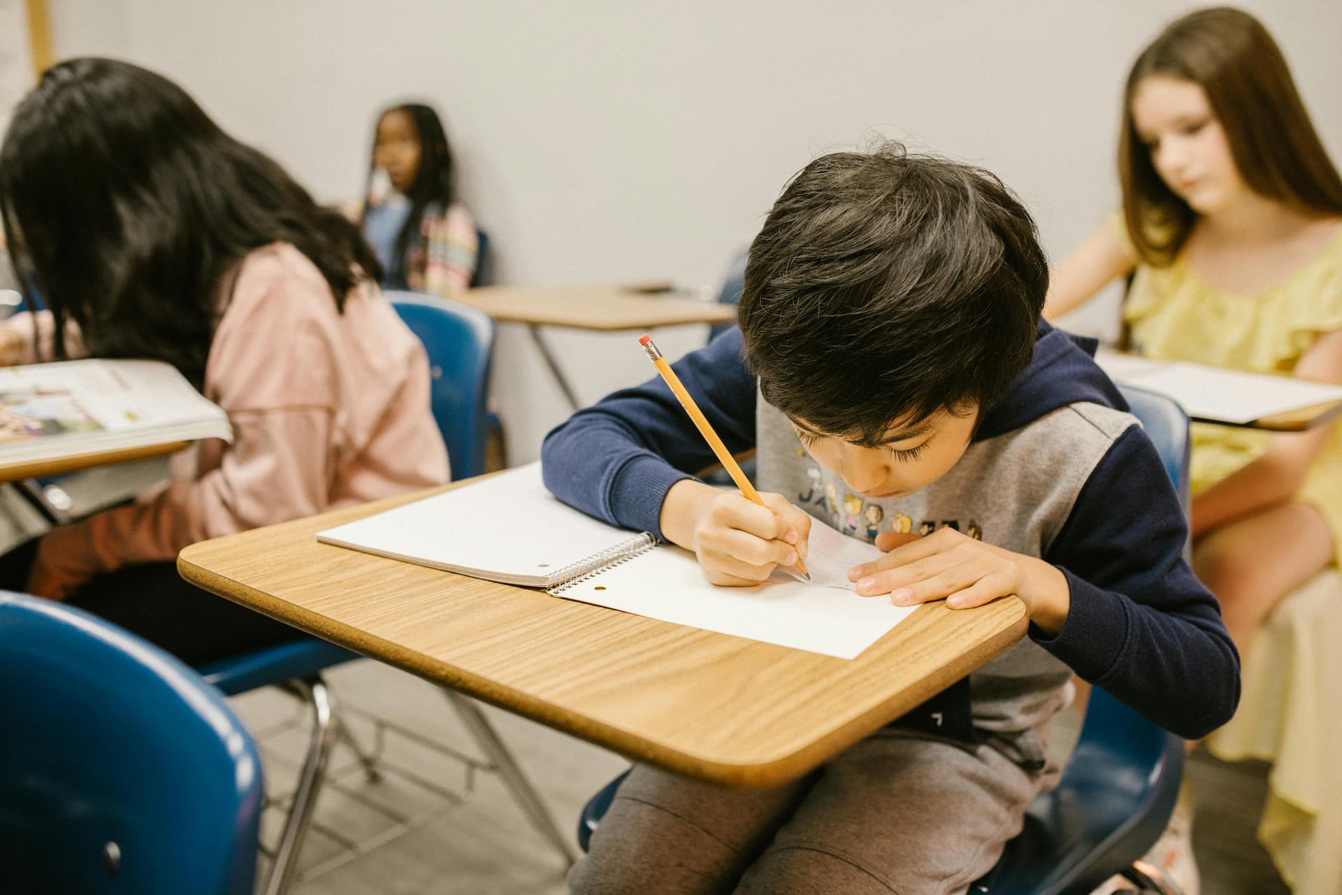 Children writing in a classroom