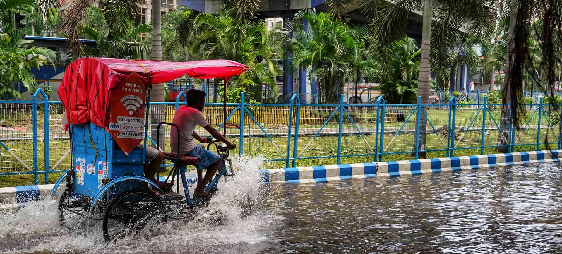 Tuk Tuk driving through flooded road