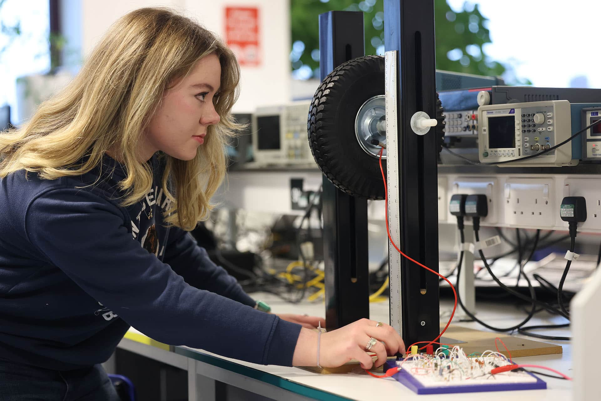 Student working with electronics and a wheel