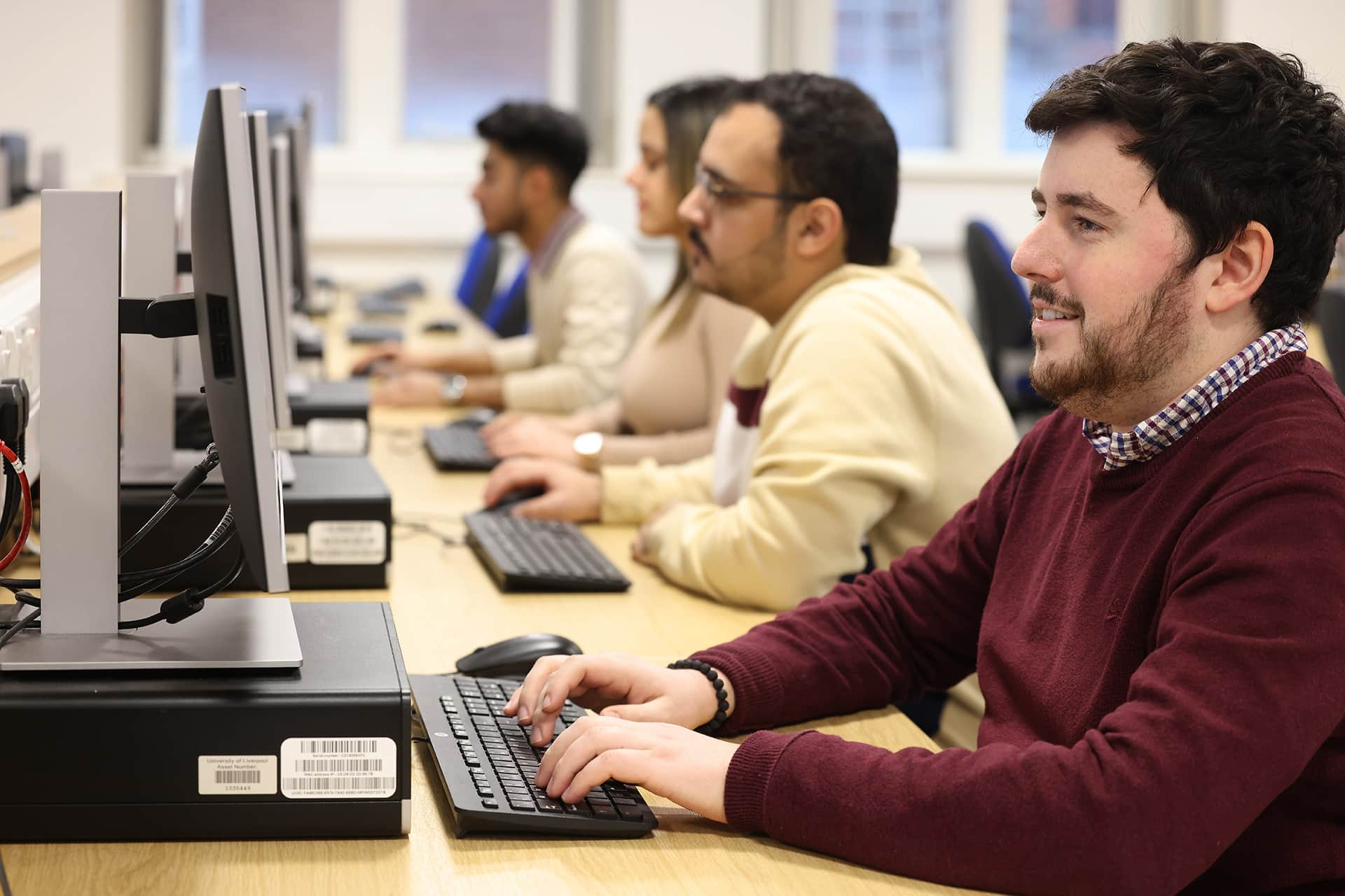 Postgraduate students working on computers