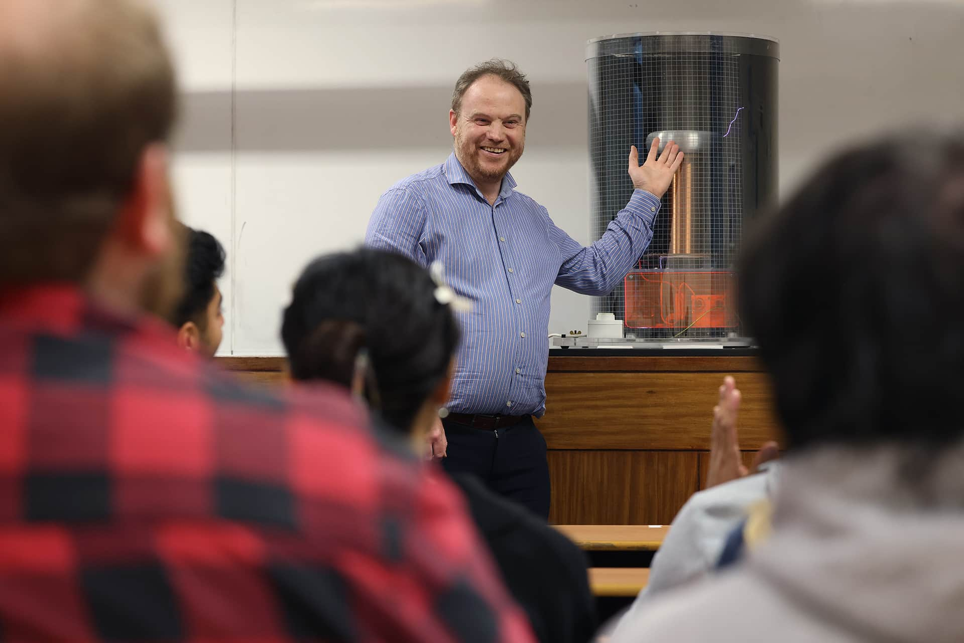 Staff member teaching a group of students