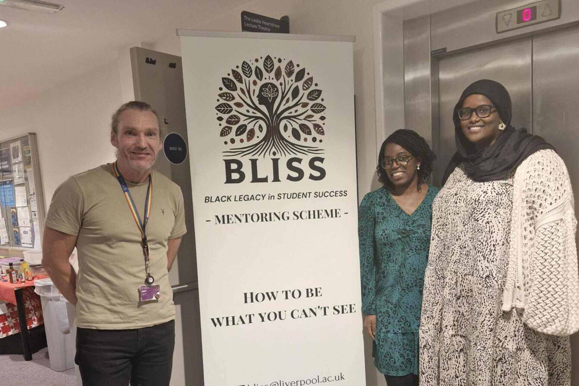 Dr Carl Larsen, Dr Oluwaseun Esan and Amal Abdulkadir pictured with a BLiSS poster