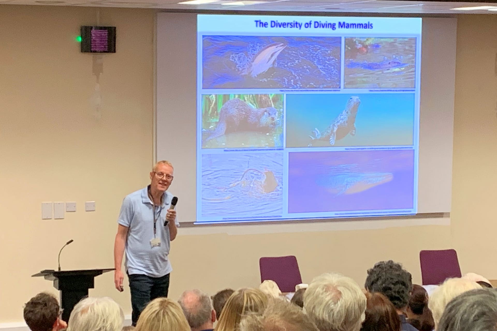 Dr Michael Berenbrink speaking in front of an audience in the lecture theatre at Ness Gardens