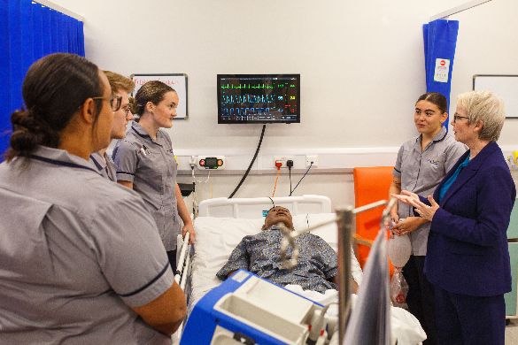 Heathcare students demonstrating their training facilities to the MP