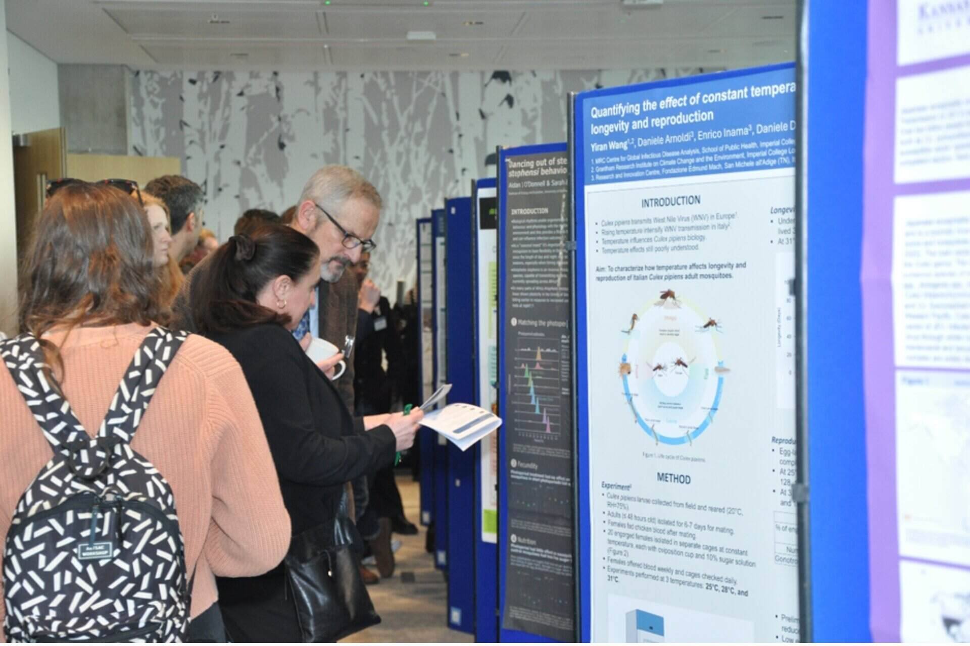 During a research poster session, Professor Matthew Baylis talking with a conference attendee.