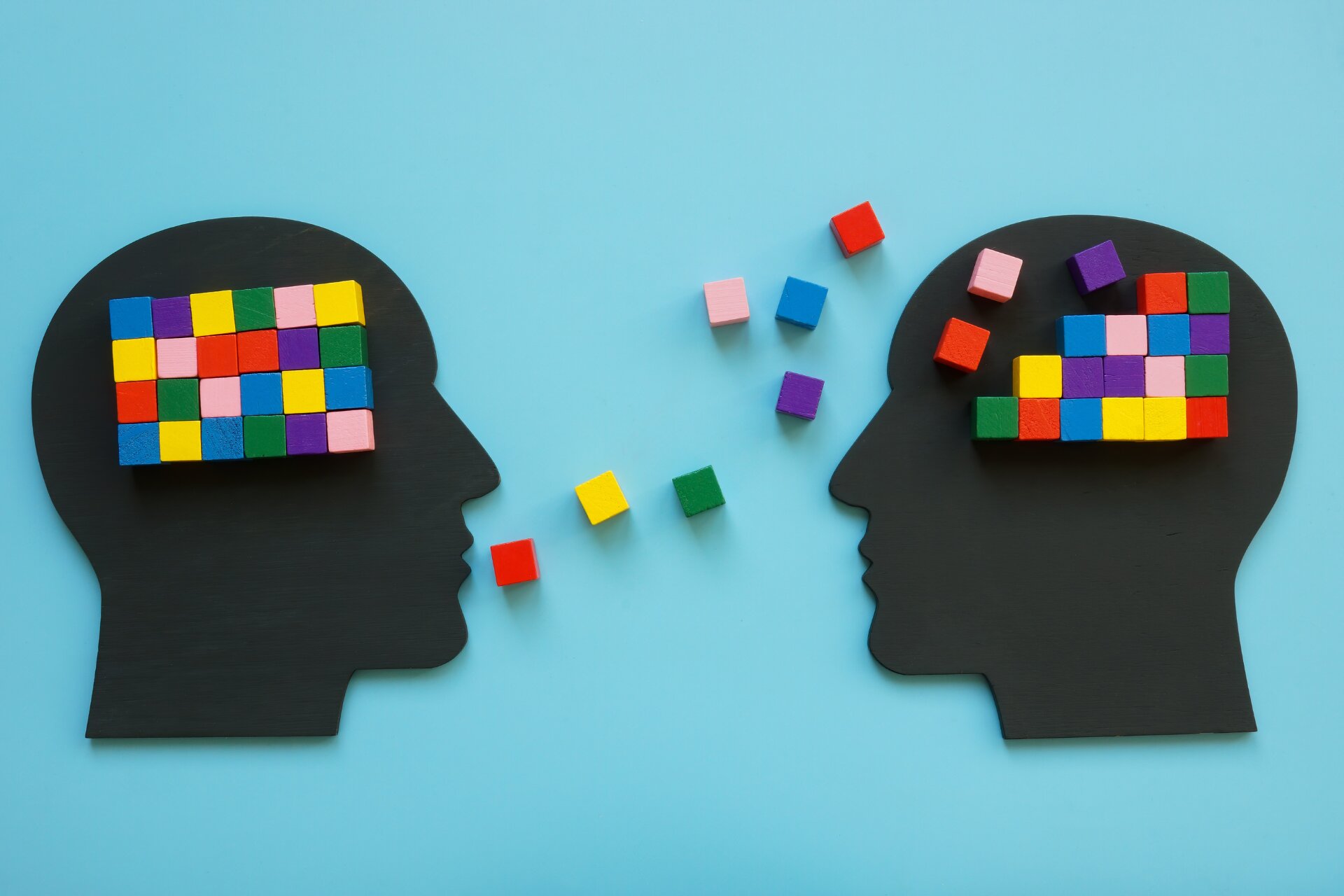 Heads with colorful cubes as a symbol of mentoring.