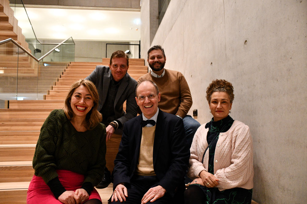 Georgia Petridou and colleagues sitting on a flight of stairs