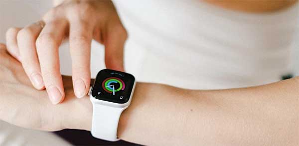 A woman checking a smart watch health tracker