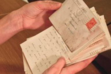 Hands holding old envelopes and letters