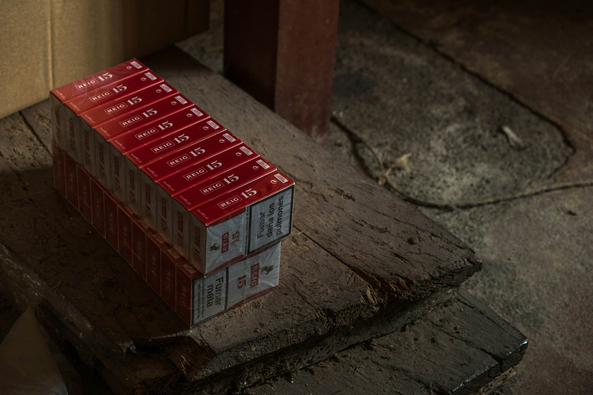 A stack of cigarette packets in a line.