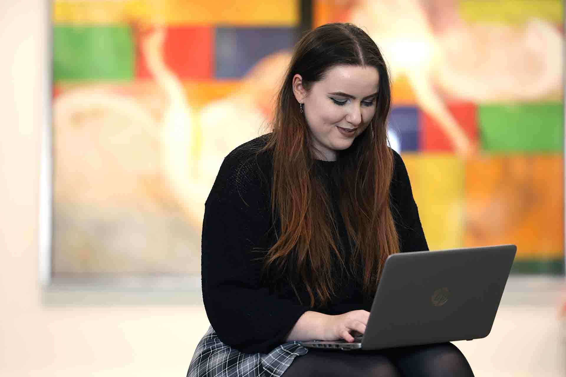 A student sat working on their laptop.