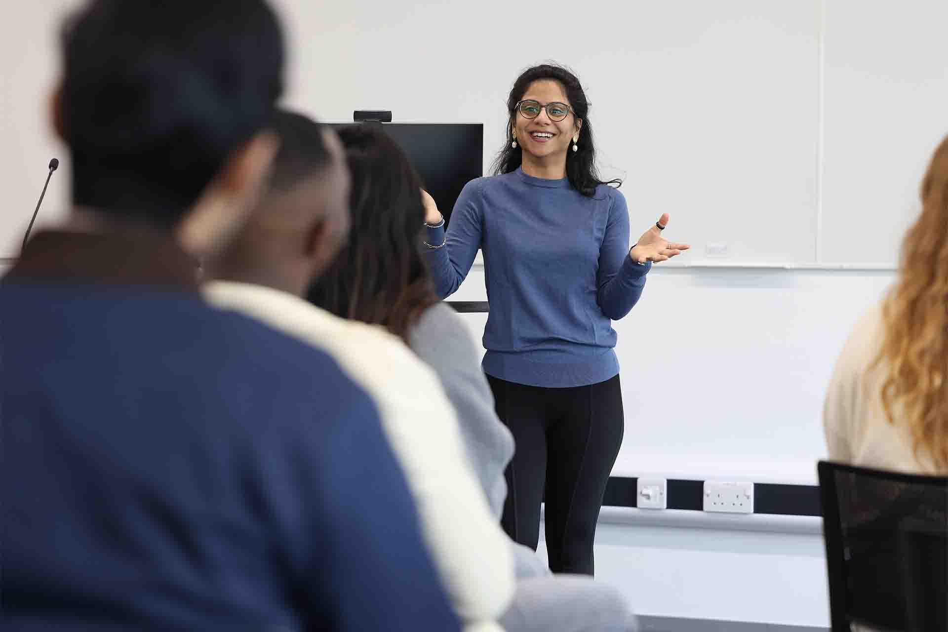 Academic giving a lecture in front of the class.