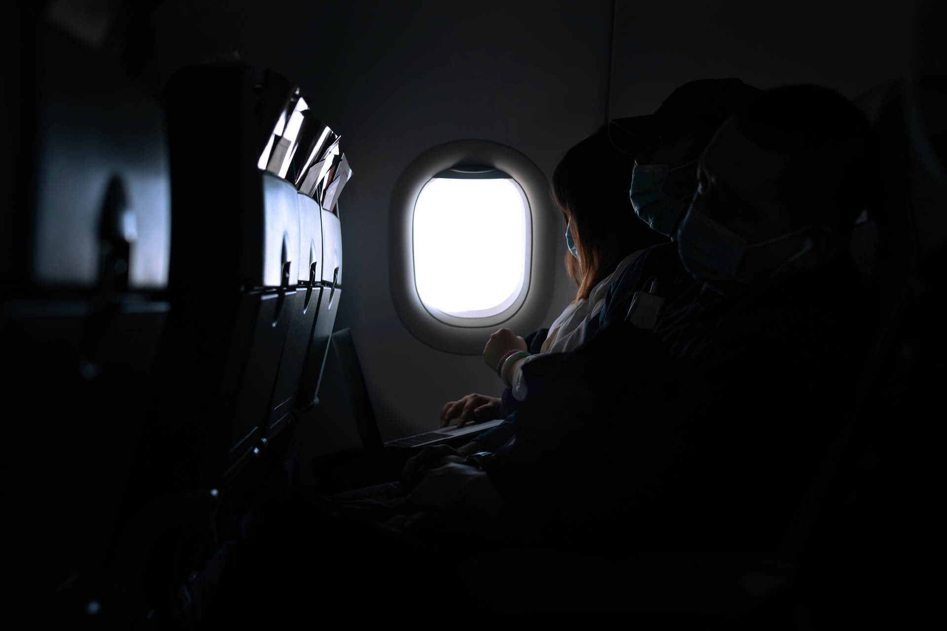 A person sat by the plane window.