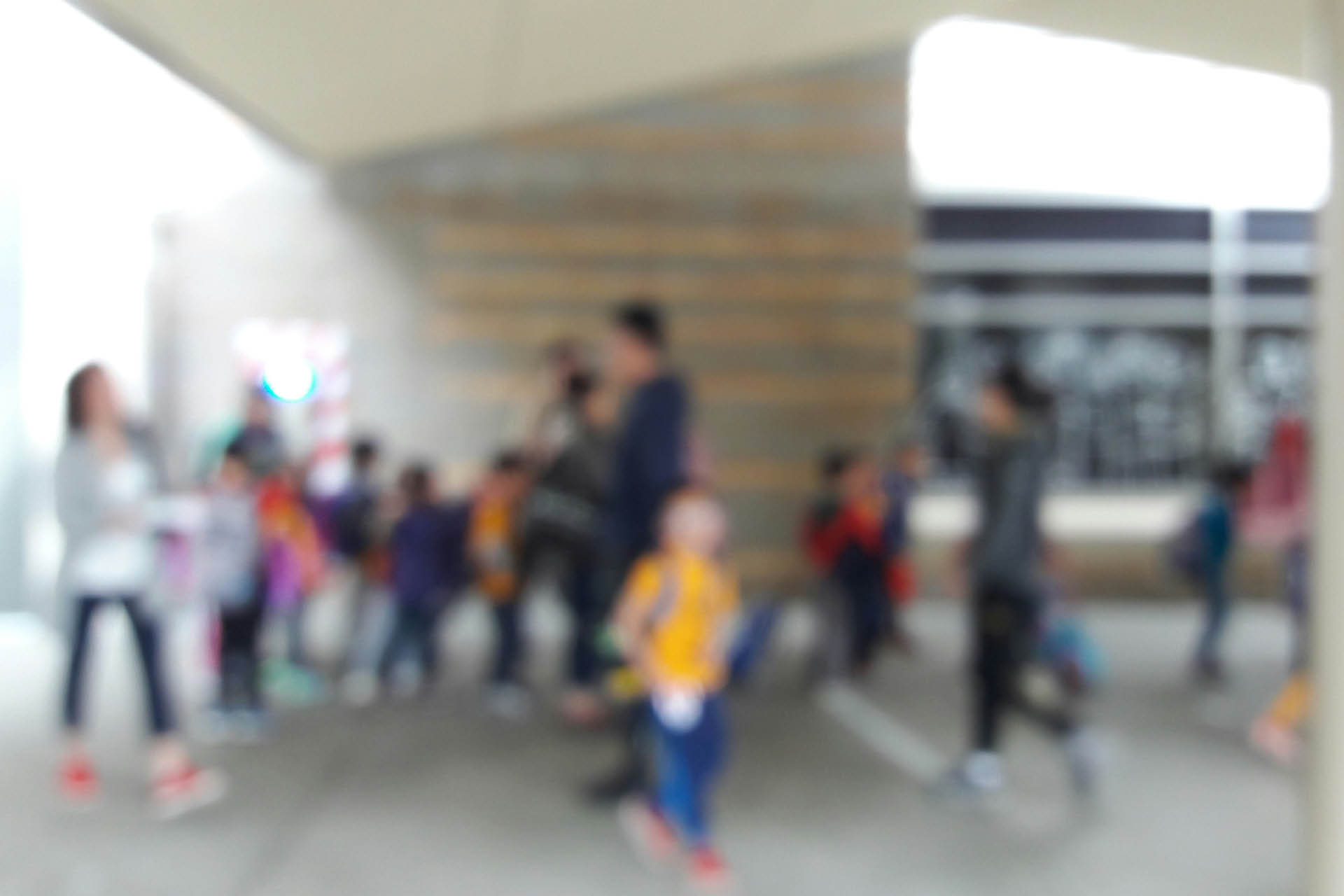 A blurred image of children playing in the playground.