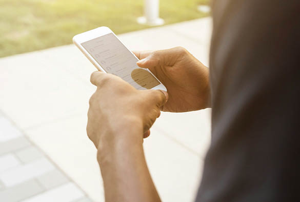 A man holding their phone texting.