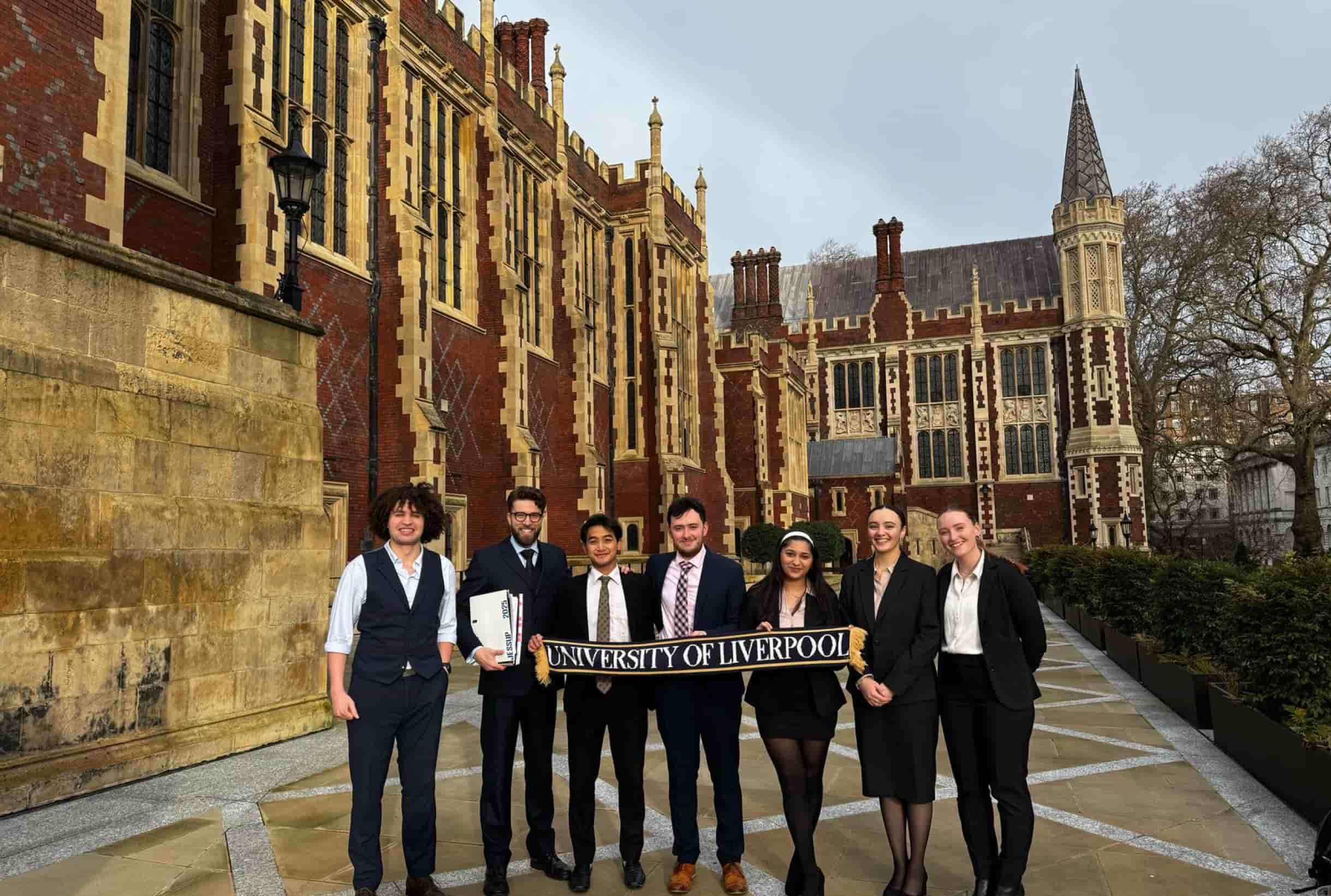 Students standing outside an old building.