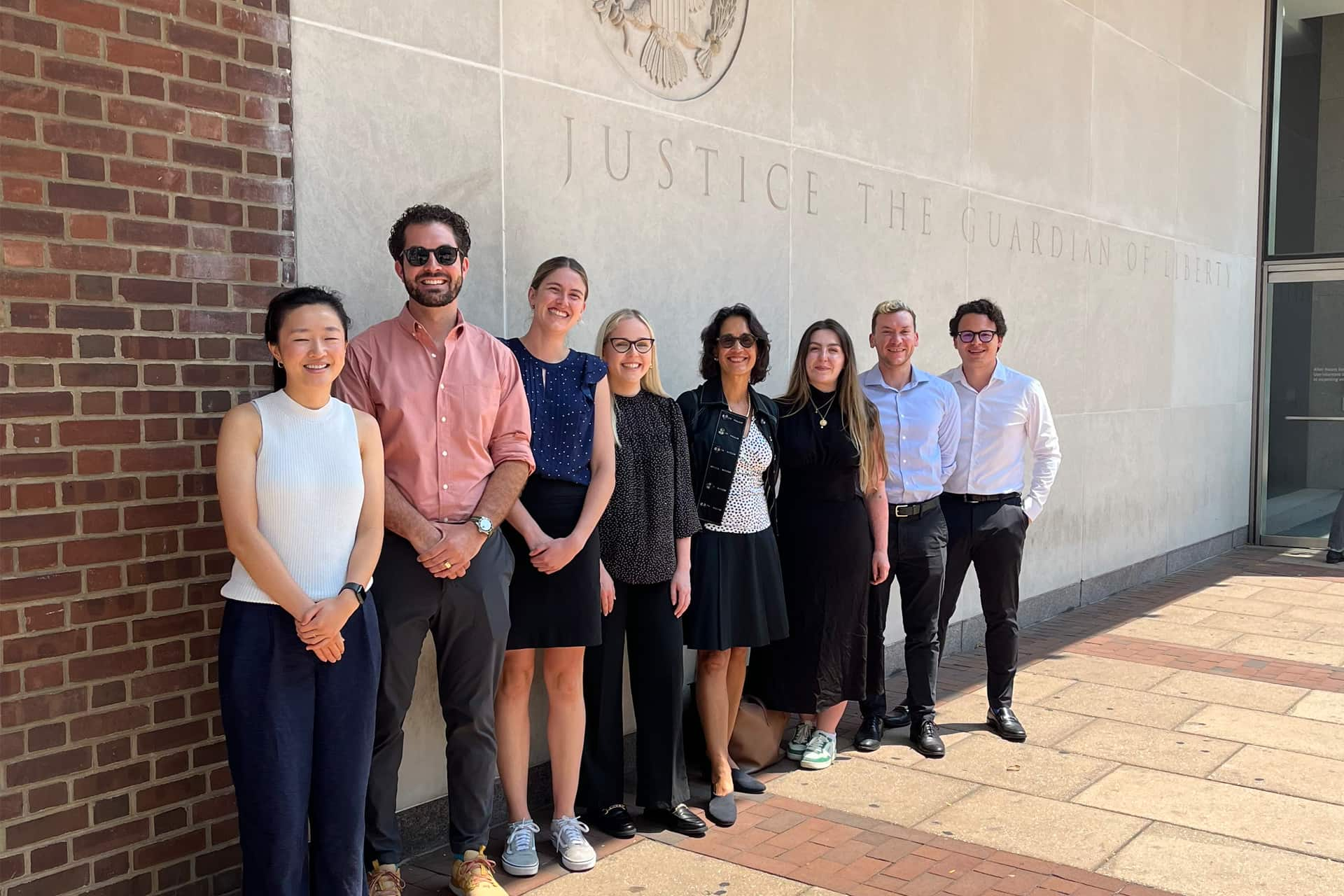 Elizabeth stands with Judge Beetlestone and her clerks.