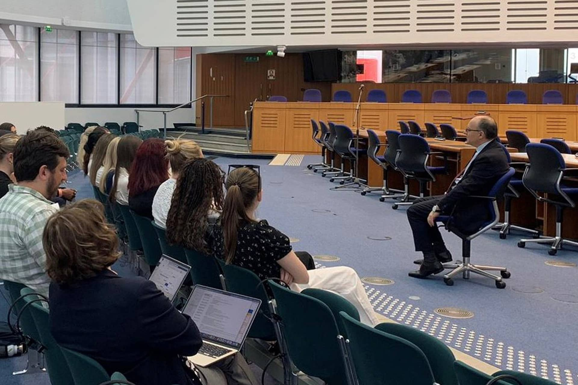 Students sit in the Court of Human Rights listening to a talk from Judge Pavli.