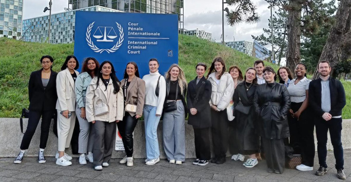A group of students standing outside of the International Criminal Court.