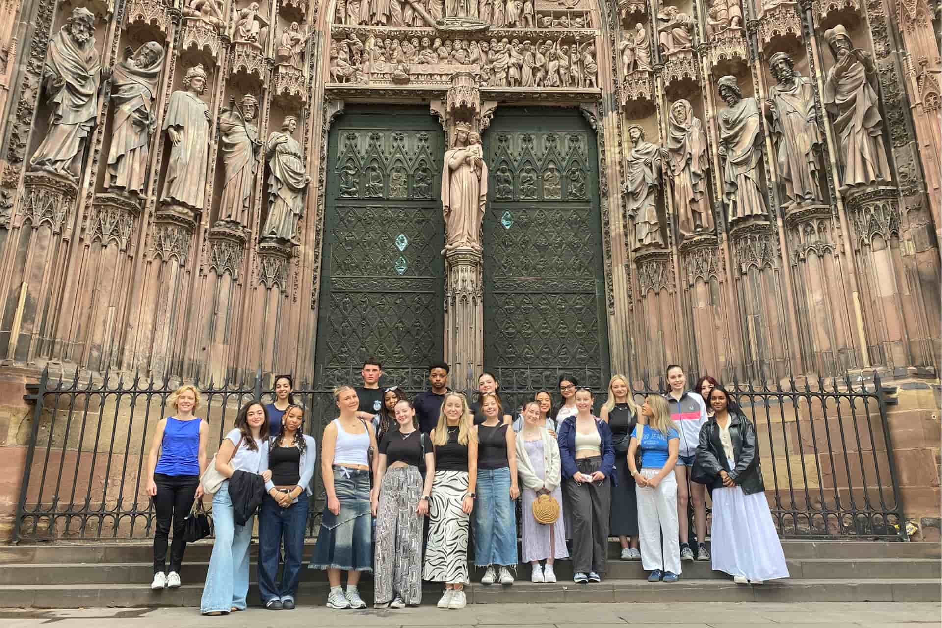 A large group of students stood outside of Stasbourg Cathedral.