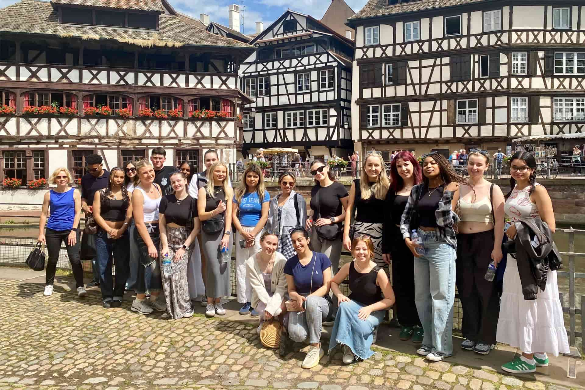 A large group of students stood in front of houses and tanneries in Strasbourg.