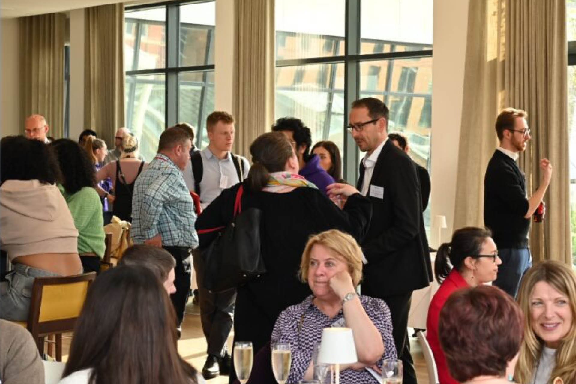 Group of people talking at an event.