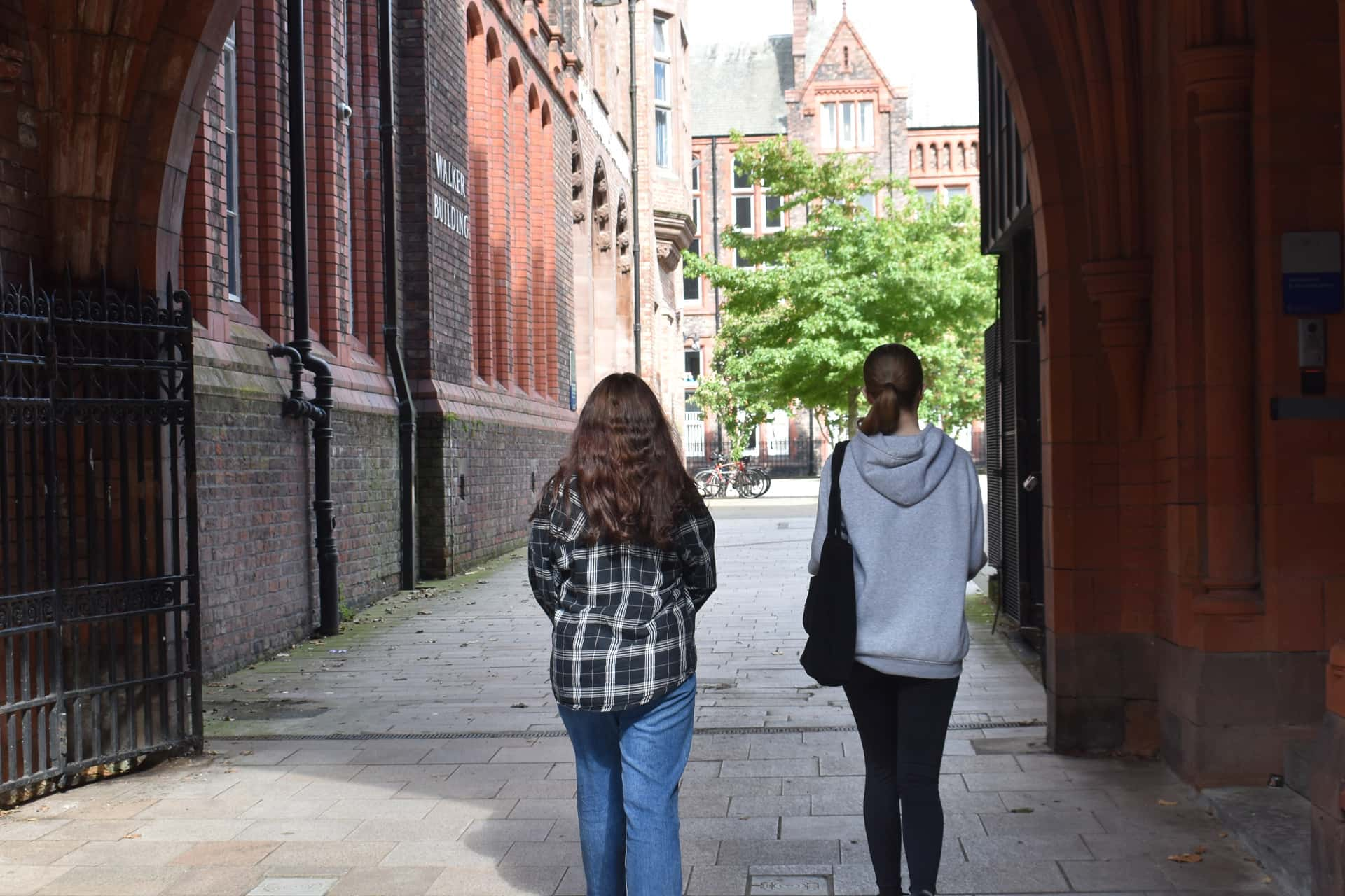 Two students walking through campus.